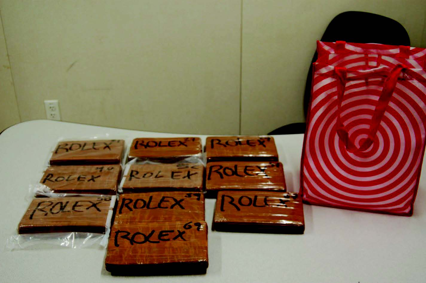 Ten brick-type packages labeled Rolex that prosecutors say held about 24.3 pounds of fentanyl seized at LAX.